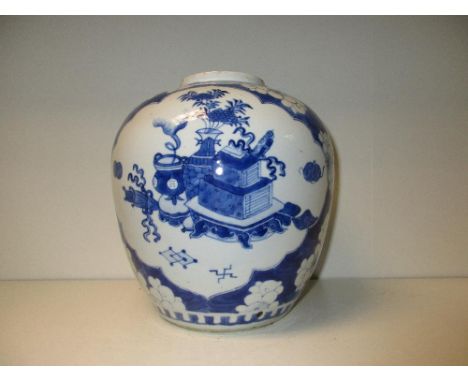 A late 19th/early 20th century blue and white jar painted with two reserves of precious objects on a ground scattered with ch