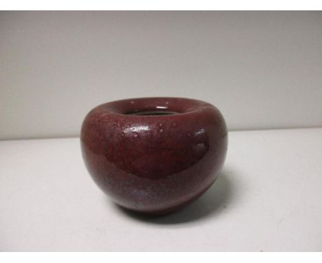 A flambe bowl, six character mark of Kangxi, the inward rolled rim above a liver red hemispherical body, marks in blue, 10cm 