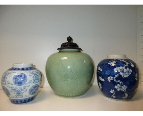 Two late 19th/early 20th century blue and white jars and another celadon, one blue and white jar decorated with floral rounde