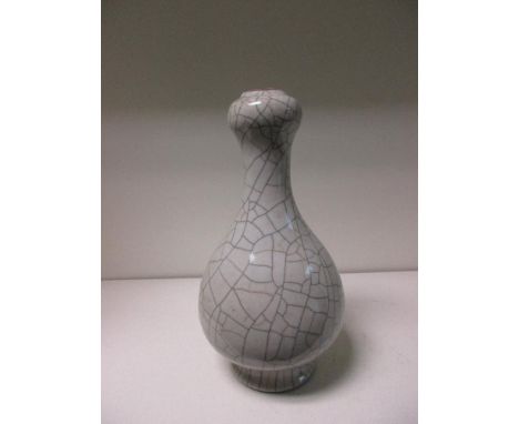 A guan type onion topped bottle vase, the crackle stained light and dark brown on the grey glazed body, 23cm (9 in) high