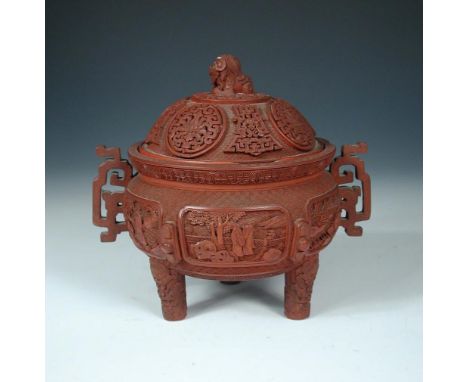 A cinnabar lacquer censer and cover, seal mark of Qianlong, the domed cover with Buddhist lion finial above roundels, the two