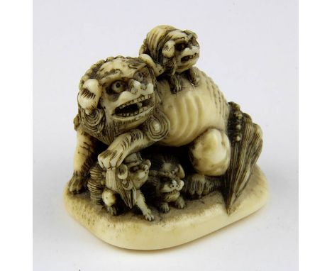 Elfenbein-Netsuke in Form eines Komainu-Wächterlöwen mit seinen 4 Jungen, Japan um 1900, aus einem Stück fein geschnitzt, im 