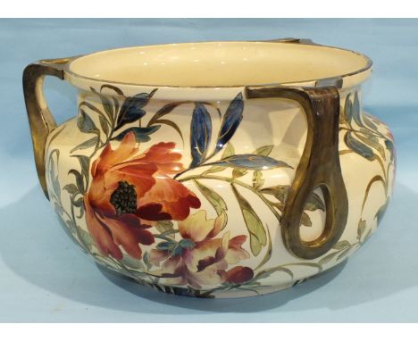 A large ceramic cauldron-shaped three-handled jardinière decorated with flowers and leaves, 29cm high, 49cm diameter, (chips 