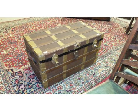 A wood and metal-bound canvas travelling trunk with interior three-partition tray, 86.5 x 47cm, 50cm high.