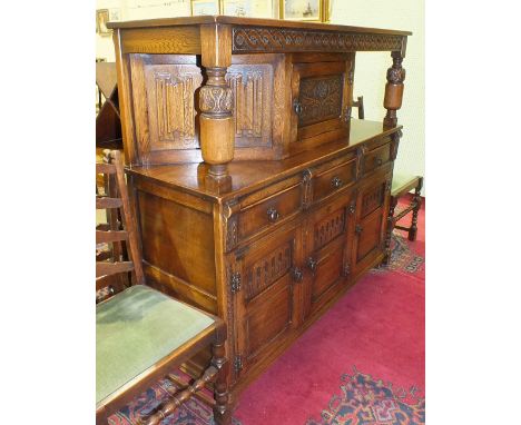 An oak draw-leaf table on bulbous end supports united by a stretcher, 121 x 76cm, closed, 181 x 76cm open and six oak dining 