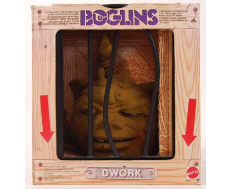 An original Mattel made Boglins creature ' Dwork .' Within the original cage designed box. Working eyes, with latex body. 