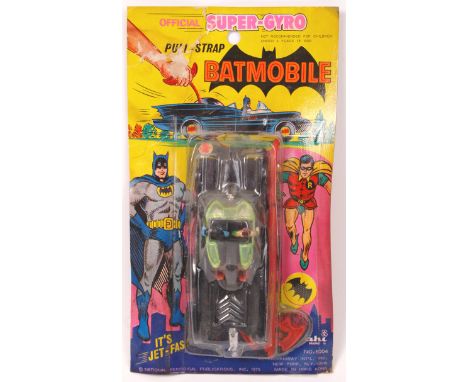 A very rare vintage 1970's Ahi made ' Pull Strap Batmobile .' Factory sealed, never removed from the original blister card pa