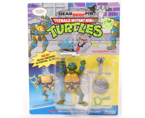 An original vintage Playmates Teenage Mutant Ninja Turtles 'Headdroppin' carded 12 back action figure of Leo. The figure stil
