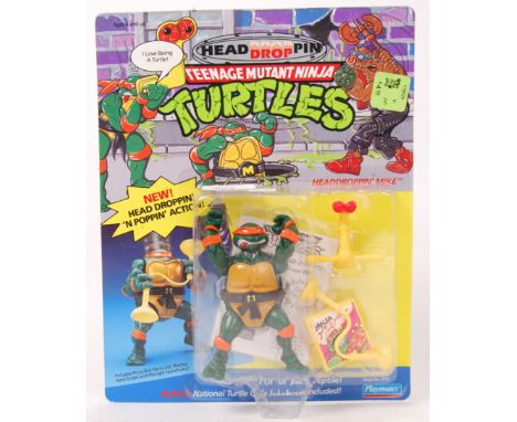 An original vintage Playmates Teenage Mutant Ninja Turtles 'Headdroppin carded 12 back action figure of Mike. The figure stil
