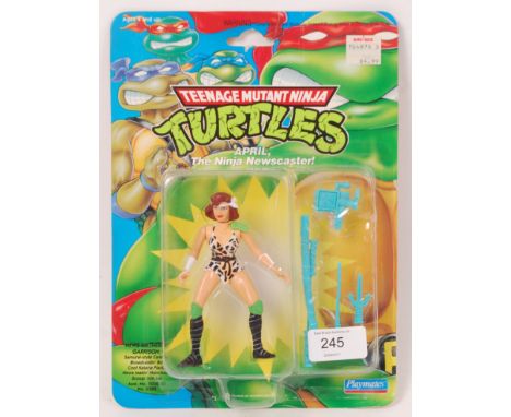 An original vintage Playmates made Teenage Mutant Ninja Turtles carded action figure ' April, The Ninja Newscaster! .' Carded