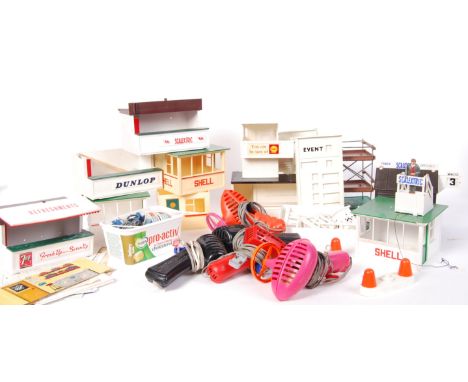 A large quantity of assorted vintage Scalextric trackside items. To include 'Starter On Rostrum' Shell hut, various stands an