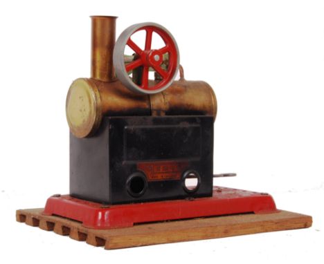 A vintage Mamod Live Steam stationary plant engine. With single piston, complete with fire tray. Mounted on a wooden base. 17