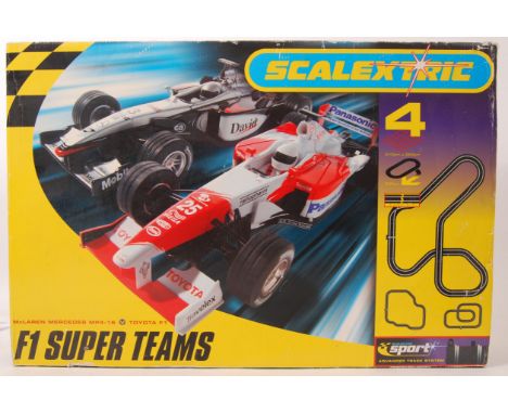 A Scalextric set ' F1 Super Teams ,' With one original correct car, and a boxed F1 car. With instructions, controllers etc.