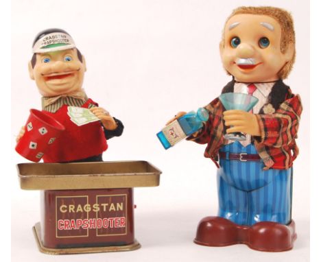 Two vintage battery operated tinplate figures. The first being a variation of Charlie Weaver the bar tender, with bottle of w