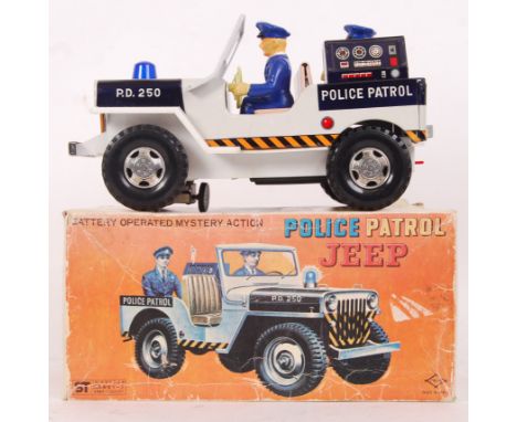 A vintage ST Toys Japanese made tinplate 'Mystery Action' battery operated 'Police Patrol Jeep.' The Jeep itself appearing mi