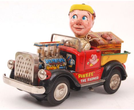 A vintage tinplate battery operated Pinkee The Farmer toy. When operated the engine pistons move, and the head pops off. Vari