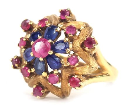 A sapphire and garnet cluster ring, with a fluted flower centre, with round brilliant cut garnets and pear shaped sapphires, 