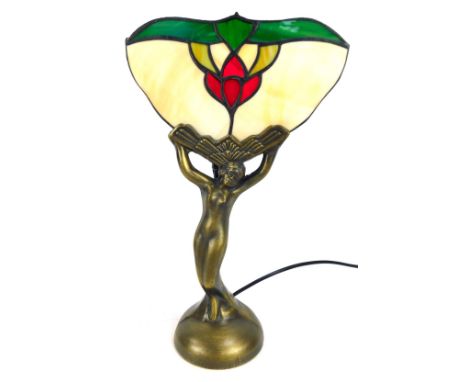 An Art Deco style table lamp, with a fluted Tiffany style glass top, with semi clad female, on bronzed effect base, 35cm high