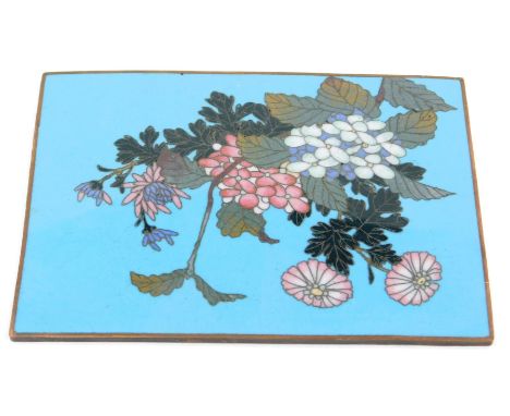 A Chinese cloisonne panel, of rectangular form, on a blue ground with floral sprays of pink flowers, 9cm x 13cm.