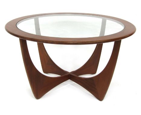 A mid century G-Plan teak Astro coffee table, the circular top inset with a glass panel above two inter-crossed U section sup