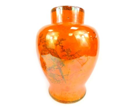 A Carltonware orange lustre jar and cover, of large proportions with dog of fo handle and hand painted black detail of parrot
