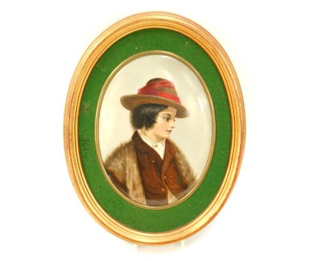 A Berlin KPM porcelain oval plaque, painted with a male figure, in fur coat and hat, with a green baize lined border, in gilt