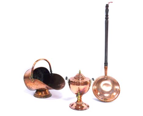 A group of 19thC copper ware, comprising a copper warming pan, copper coal helmet with swing handle, 40cm wide, and a tea urn