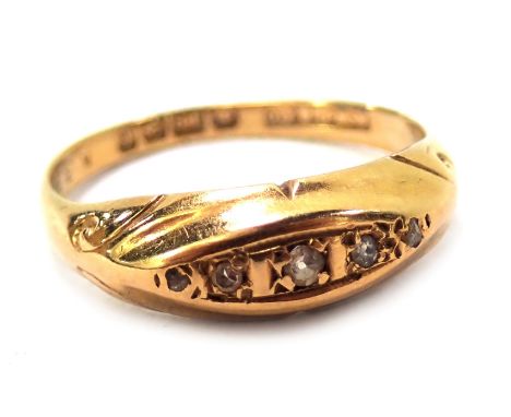 An 18ct gold diamond gypsy ring, the panel set with five tiny diamonds, with scroll design shoulders, ring size L½, 2.7g. 