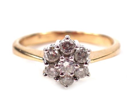 A 9ct gold cluster ring, with arrangement of seven CZ stones, in white gold claw setting on a yellow metal band, size O, 2.9g