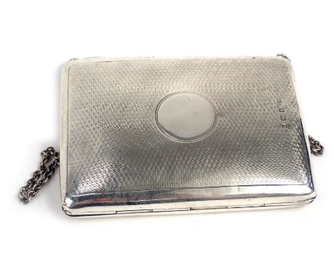 A George V silver coin purse, the outer case with engine turned decorated and vacant circle cartouche, with a blue satin inte