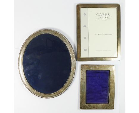 An oval silver photograph frame, Sheffield 1993, 27.5 x 22.5cm, another 2013 and a third Birmingham 1909, all with no easel b