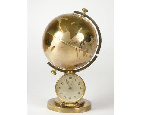 A 1950's novelty cigarette dispensing manel clock, having a jeweled Swiss 8 day movement, incorporating a globe which opens t