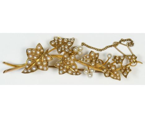 A Victorian unmarked 15ct gold and half pearl set ivy leaf brooch, 7.5cm, 12.3gm 