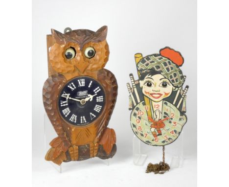 A 1950s novelty wall clock, in the form of a owl, having mechanical movement with 'moving eyes', made in occupied Japan, 27cm