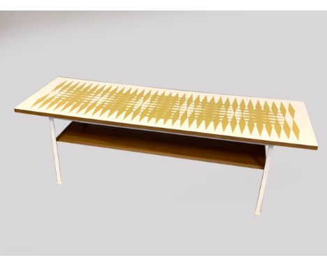 Terence Conran - 1960s rectangular coffee table, white formica top with gold geometric design, undertier shelf raised on pain