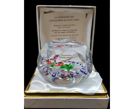 A Saint Louis glass paperweight, a bouquet of five flowers enclosed in a ring of blue/white millefiori canes including signat