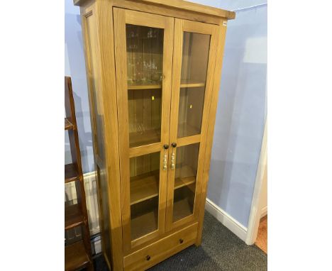 A light oak display cabinet