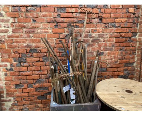 A selection of garden tools, including rakes, spades and forks