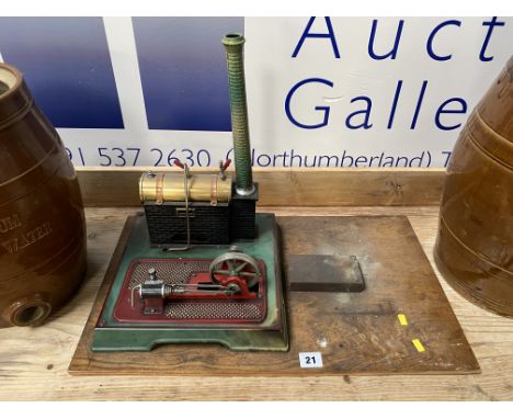 A Marklin stationary engine, of tin plate construction and measuring H 40cm, raised on a rectangular wooden base