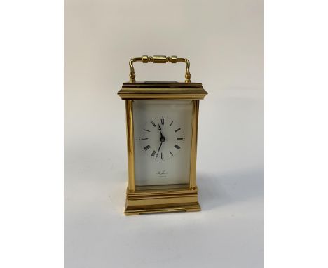 A 20th century gilt metal carriage clock, St. James of London, with enamelled Roman dial, H 16cm