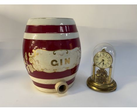 An early 20th century ceramic Gin barrel, hand painted, H 33cm and a Continental perpetual motion mantle clock