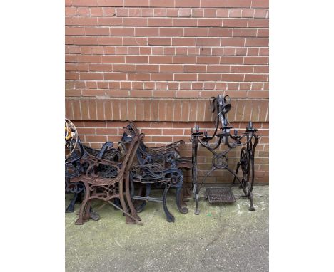 A selection of painted cast iron bench ends and other metalware including a treadle base