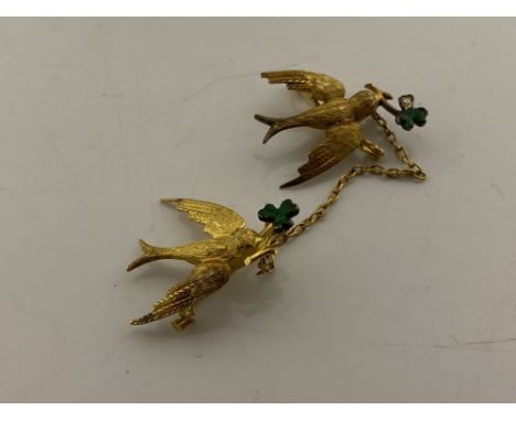 A pair of 15ct and enamel swallow brooches