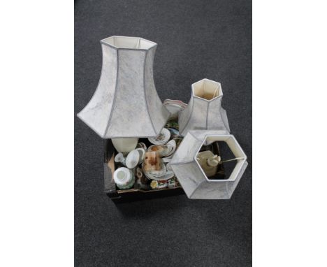 A box of miscellaneous china, mug and mug tree, table lamp shades 
