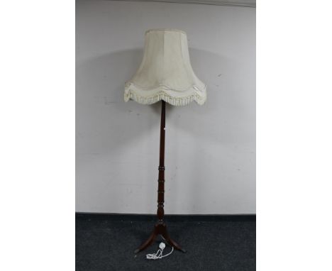 A mahogany standard lamp with shade on tripod stand 