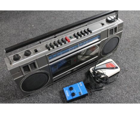 A Sanyo radio with twin cassette deck together with a Ferguson walkman and headphone, Binatone stereo radio 