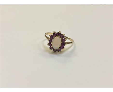 A yellow gold opal and ruby cluster ring, size N/O, 1.9g (hallmarks rubbed).