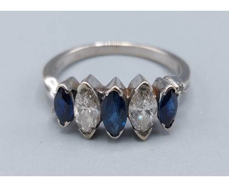 A 18ct gold Sapphire and diamond ring set with two Marquise cut diamonds with three similar Sapphire flanked by two small Dia