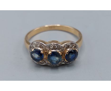 An 18ct gold Diamond and Sapphire triple cluster ring, 3.7gms, ring size O 