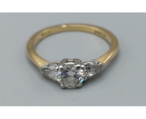 An 18ct gold three stone diamond ring, the central diamond approximately 0.50ct flanked by pear shaped diamonds approximately